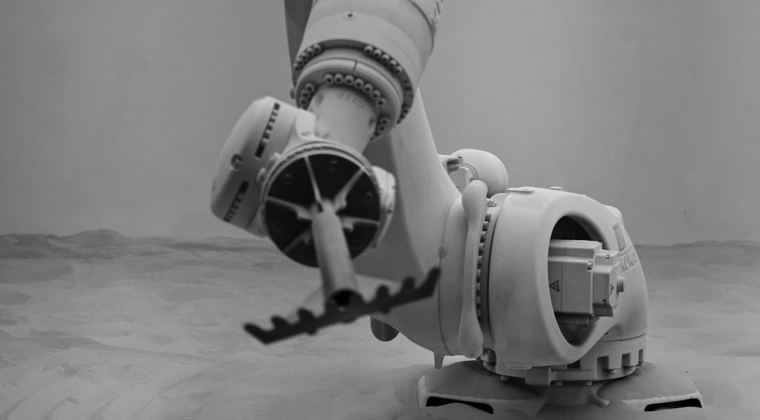 Modern white robot arm in a factory automation setting